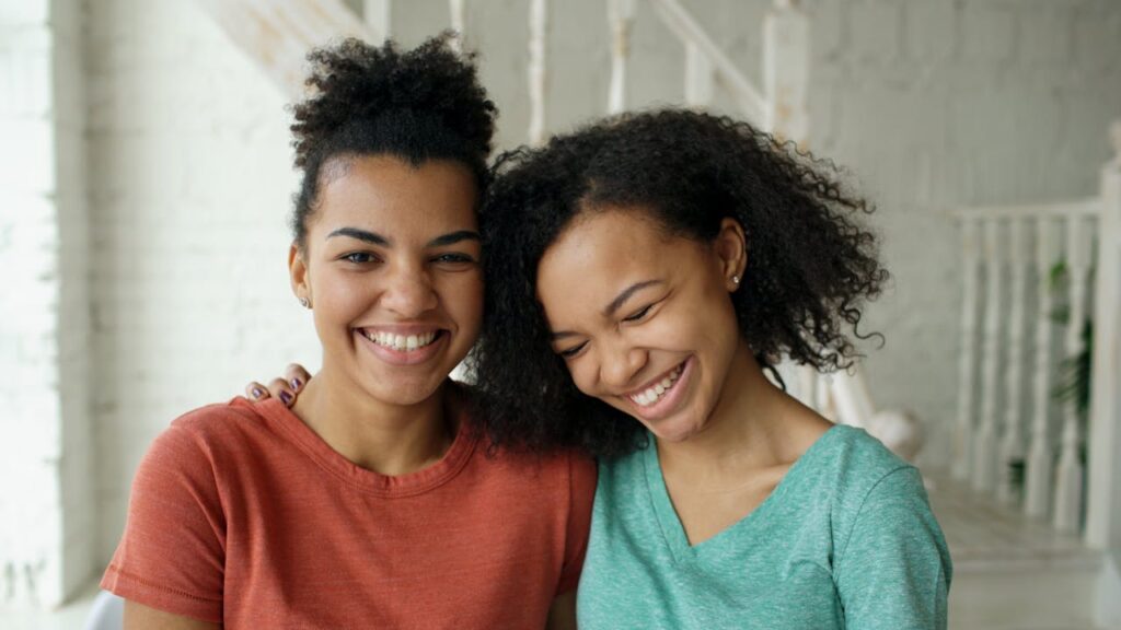 pexels-photo-36812655 Two young women sharing a joyful moment indoors, showcasing friendship and happiness.